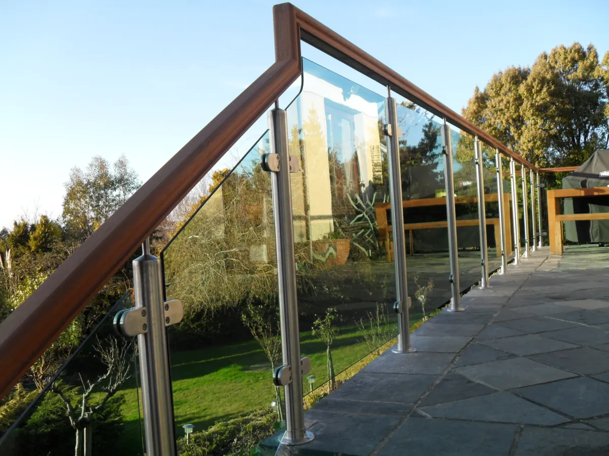 Glass infill balustrade along a garden terrace